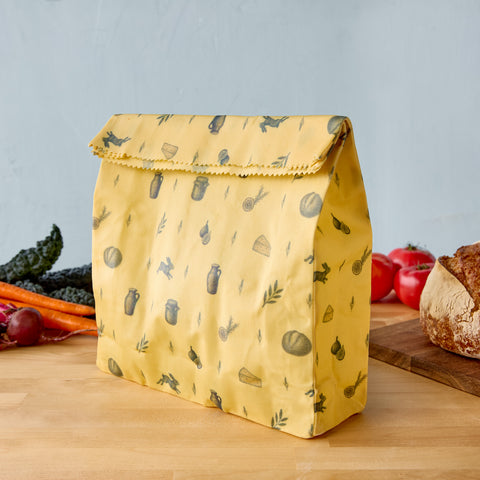 Beeswax pantry bag with vegetable print, fold-over top and sewn seams, yellow fabric